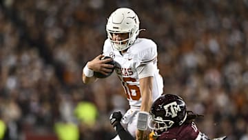 Texas Longhorns quarterback Arch Manning runs the ball against the Texas A&M Aggies