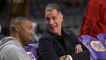 Nov 21, 2024; Los Angeles, California, USA;  Los Angeles Lakers general manager Rob Pelinka, right, talks with Leroy Sims, director of player performance & health, prior to the game against the Orlando Magic at Crypto.com Arena. Mandatory Credit: Jayne Kamin-Oncea-Imagn Images