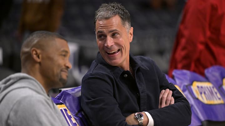 Nov 21, 2024; Los Angeles, California, USA;  Los Angeles Lakers general manager Rob Pelinka, right, talks with Leroy Sims, director of player performance & health, prior to the game against the Orlando Magic at Crypto.com Arena. Mandatory Credit: Jayne Kamin-Oncea-Imagn Images