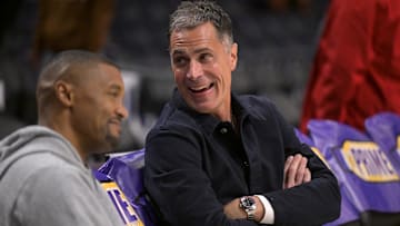 Los Angeles Lakers general manager Rob Pelinka, right, talks with Leroy Sims, director of player performance and health, prior to the game against the Orlando Magic at Crypto.com Arena.