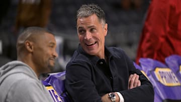 Nov 21, 2024; Los Angeles, California, USA;  Los Angeles Lakers general manager Rob Pelinka, right, talks with Leroy Sims, director of player performance & health, prior to the game against the Orlando Magic at Crypto.com Arena. Mandatory Credit: Jayne Kamin-Oncea-Imagn Images