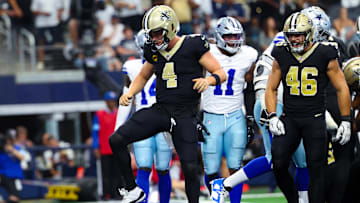 Sep 15, 2024; Arlington, Texas, USA; New Orleans Saints quarterback Derek Carr (4) celebrates after scoring a touchdown  during the first half against the Dallas Cowboys at AT&T Stadium. Mandatory Credit: Kevin Jairaj-Imagn Images