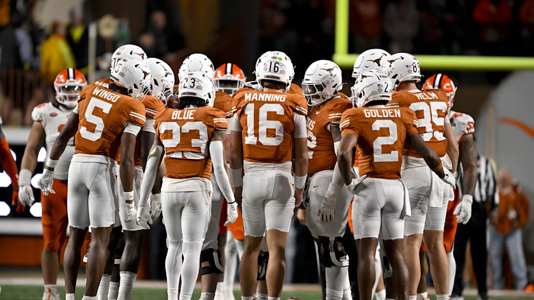 Dec 21, 2024; Austin, Texas, USA; Texas Longhorns wide receiver Ryan Wingo (5) and running back Jaydon Blue (23) and quarterback Arch Manning (16) and wide receiver Matthew Golden (2) huddle with the team during the game between the Texas Longhorns and the Clemson Tigers in the CFP National Playoff First Round at Darrell K Royal-Texas Memorial Stadium. Mandatory Credit: Jerome Miron-Imagn Images
