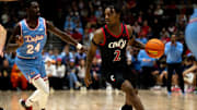 Cincinnati Bearcats guard Jizzle James (2) drives on Dayton Flyers guard Kobe Elvis (24) in the second half of the NCAA men's basketball game between the Dayton Flyers and Cincinnati Bearcats at Heritage Bank Center in Cincinnati on Saturday, Dec. 16, 2023.