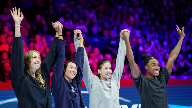 Gretchen Walsh, Torri Huske, Kate Douglass and Simone Manuel wave to the crowd after the 100-meter freestyle final.
