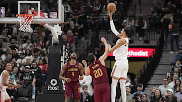 San Antonio Spurs forward Victor Wembanyama (1) shoots over Cleveland Cavaliers forwards Georges Niang (20) and Evan Mobley (4) during the second half at Frost Bank Center. Mandatory Credit: Scott Wachter-Imagn Images