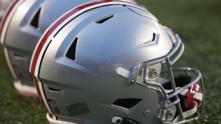 Oct 28, 2023; Madison, Wisconsin, USA;  Ohio State Buckeyes helmets sit on the field during warmups prior to the game against the Wisconsin Badgers at Camp Randall Stadium.