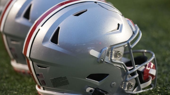 Oct 28, 2023; Madison, Wisconsin, USA;  Ohio State Buckeyes helmets sit on the field during warmups prior to the game against the Wisconsin Badgers at Camp Randall Stadium.