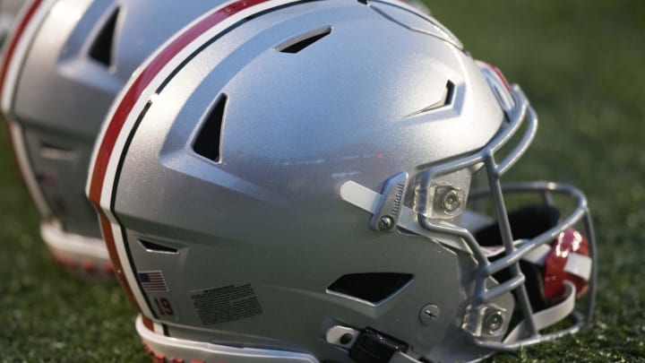 Oct 28, 2023; Madison, Wisconsin, USA;  Ohio State Buckeyes helmets sit on the field during warmups prior to the game against the Wisconsin Badgers at Camp Randall Stadium.