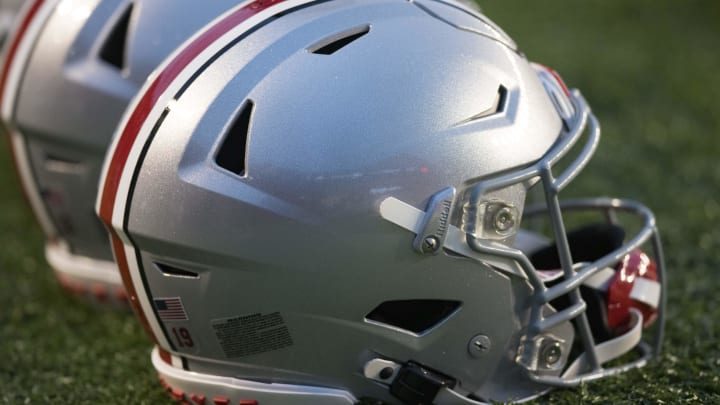 Oct 28, 2023; Madison, Wisconsin, USA;  Ohio State Buckeyes helmets sit on the field during warmups prior to the game against the Wisconsin Badgers at Camp Randall Stadium.