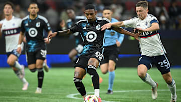 Minnesota United midfielder Joseph Rosales (8) controls the ball against Vancouver Whitecaps FC midfielder Ryan Gauld (25)  