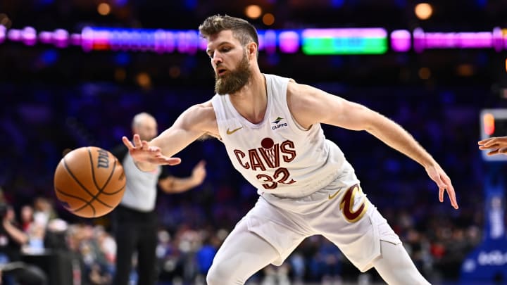 Feb 23, 2024; Philadelphia, Pennsylvania, USA; Cleveland Cavaliers forward Dean Wade (32) reaches for a loose ball against the Philadelphia 76ers in the first quarter at Wells Fargo Center. Mandatory Credit: Kyle Ross-USA TODAY Sports