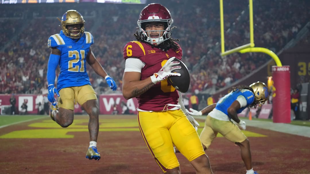 Southern California Trojans wide receiver Makai Lemon (6) catches a 32-yard touchdown pass against UCLA Bruins defensive back Kanye Clark (1) in the second half at United Airlines Field at Los Angeles Memorial Coliseum. Mandatory Credit: Kirby Lee-Imagn Images