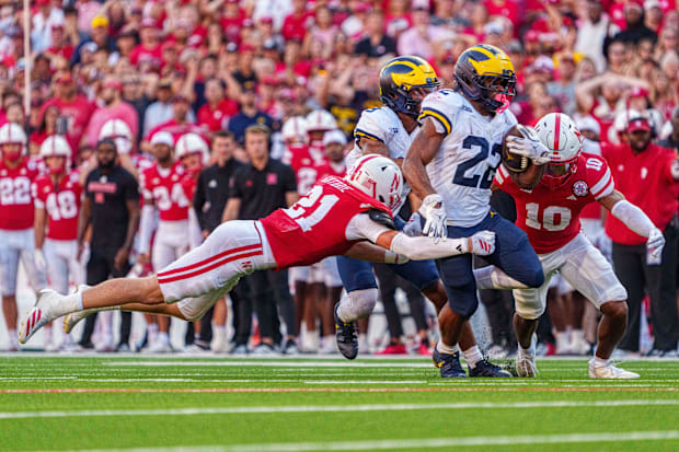 Michigan Wolverines running back Jordan Marshall is tackled.