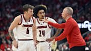 Feb 22, 2025; Louisville, Kentucky, USA;  Louisville Cardinals head coach Pat Kelsey talks with guard Reyne Smith (6) and guard Chucky Hepburn (24) during the first half against the Florida State Seminoles at KFC Yum! Center. Mandatory Credit: Jamie Rhodes-Imagn Images