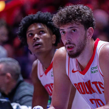 Jan 12, 2024; Detroit, Michigan, USA; Houston Rockets center Alperen Sengun (28) and forward Amen Thompson (1) sit on the sidelines on a play stoppage against the Detroit Pistons during the in the first half at Little Caesars Arena. Mandatory Credit: David Reginek-Imagn Images
