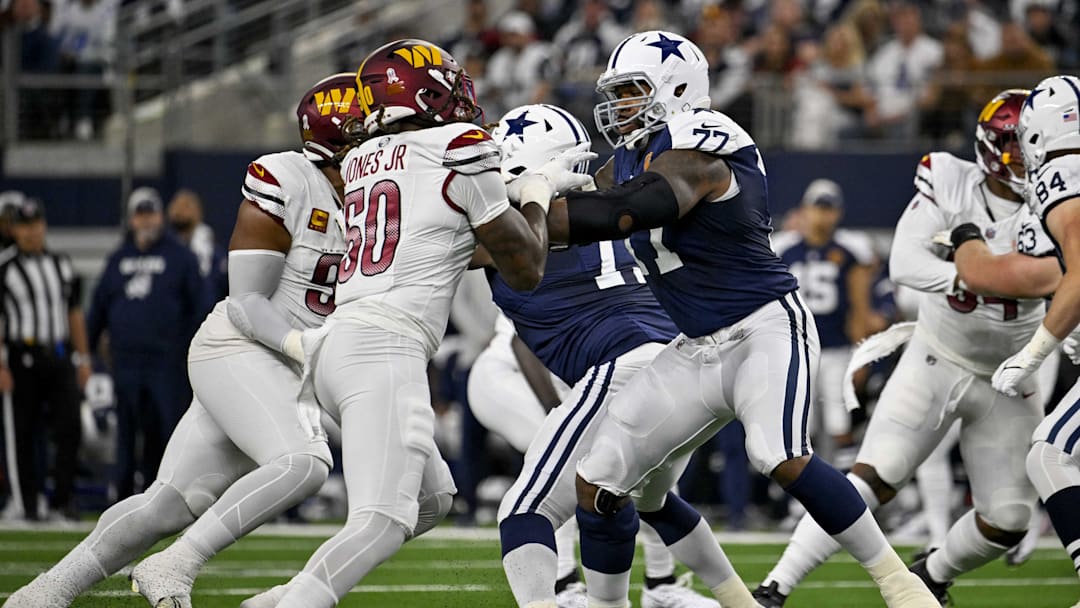 Nov 23, 2023; Arlington, Texas, USA; Washington Commanders defensive end Andre Jones Jr. (50) and Dallas Cowboys offensive tackle Tyron Smith (77) in action during the game between the Dallas Cowboys and the Washington Commanders at AT&T Stadium. Mandatory Credit: Jerome Miron-Imagn Images