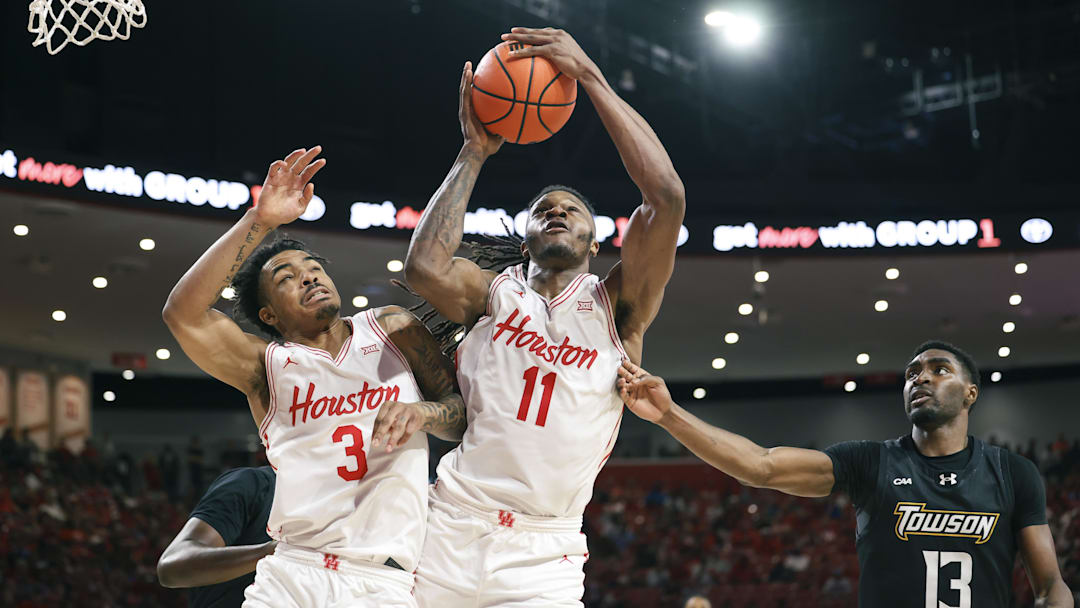 Nov 8, 2025; Houston, Texas, USA; Houston Cougars forward Joseph Tugler (11) and guard Ramon Walker Jr. (3) attempt to get a rebound away from Towson Tigers forward Chike Ndefo (13) during the first half at Fertitta Center. 