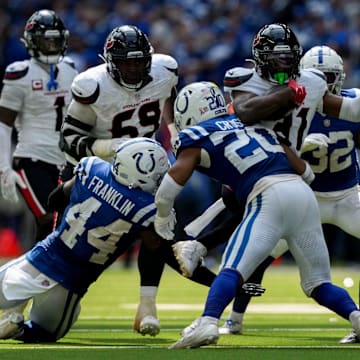 Houston Texans running back Dameon Pierce (31) is brought down by a slew of Indianapolis Colts defenders Sunday, Sept. 8, 2024, during a game against the Houston Texans at Lucas Oil Stadium in Indianapolis.