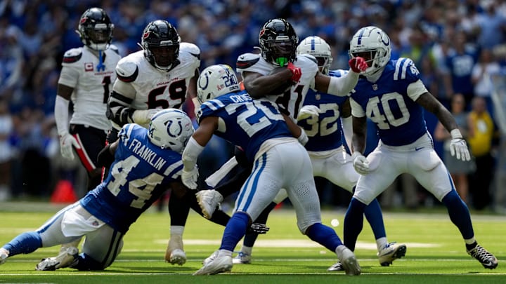 Houston Texans running back Dameon Pierce (31) is brought down by a slew of Indianapolis Colts defenders Sunday, Sept. 8, 2024, during a game against the Houston Texans at Lucas Oil Stadium in Indianapolis.