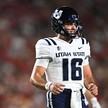 Sep 7, 2024; Los Angeles, California, USA; Utah State Aggies quarterback Bryson Barnes (16) and Utah State Aggies running back Rahsul Faison (3) react against the USC Trojans during the second quarter at United Airlines Field at Los Angeles Memorial Coliseum. Mandatory Credit: Jonathan Hui-Imagn Images