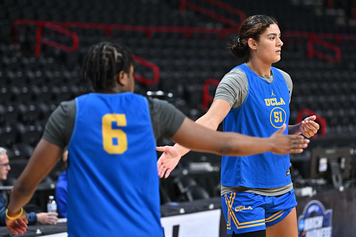 UCLA Bruins center Lauren Betts high fives forward Zania Socka-Nguemen during an NCAA Tournament practice session.