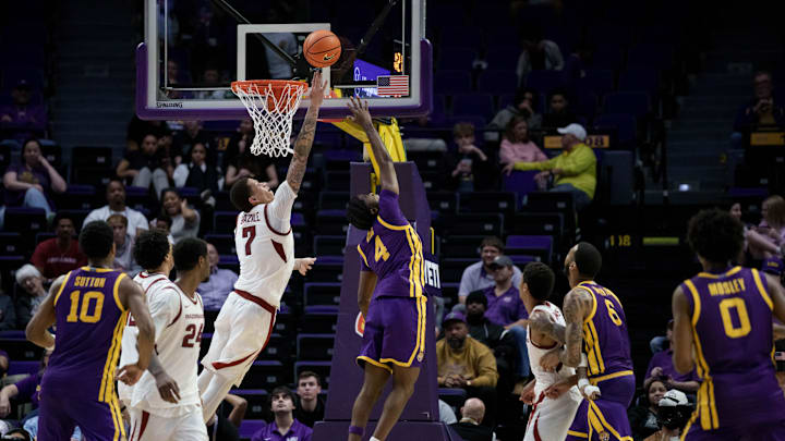 Feb 10, 2026; Baton Rouge, Louisiana, USA; LSU Tigers guard Rashad King (4) shoots against Arkansas Razorbacks forward Trevon Brazile (7) during the second half at Pete Maravich Assembly Center. Mandatory Credit: Matthew Hinton-Imagn Images