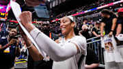 Las Vegas Aces center Wilson (22) signs a poster at Gainbridge Fieldhouse in Indianapolis
