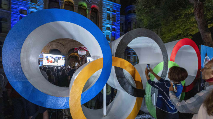 Jul 24, 2024; Salt Lake CIty, Utah, USA; Utah Olympic fans take a photo through the Olympic rings after the announcement for the host city for the 2034 Winter Olympic and Paralympic Games at Washington Square. Mandatory Credit: Christopher Creveling-USA TODAY Sports