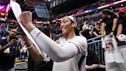 Sep 13, 2024; Indianapolis, Indiana, USA; Las Vegas Aces center A'ja Wilson (22) signs a poster Friday, Sept. 13, 2024, during a game between the Indiana Fever and the Las Vegas Aces on Friday, Sept. 13, 2024, at Gainbridge Fieldhouse in Indianapolis. The Aces defeated the Fever, 78-74.  