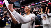 Las Vegas Aces center A'ja Wilson signs a poster during a game against the Indiana Fever.