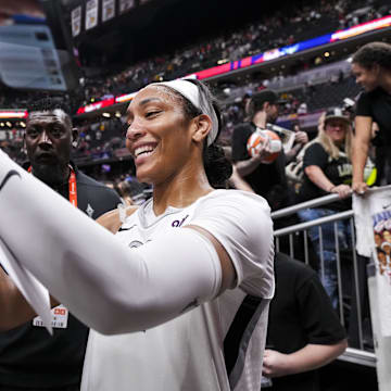 Las Vegas Aces center A'ja Wilson (22) signs a poster