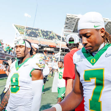 Oregon Ducks wide receiver Evan Stewart reacts to childhood photos