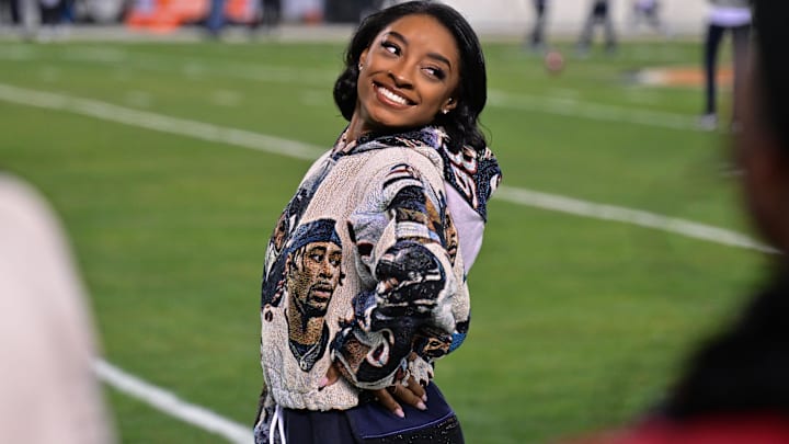 United States gymnast Simone Biles poses for a photo on the sidelines before the game between the Chicago Bears and the Seattle Seahawks at Soldier Field.