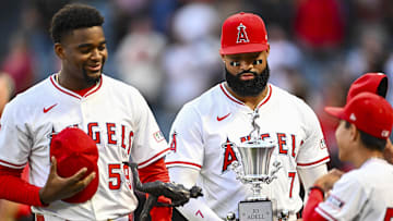 Sep 27, 2025; Anaheim, California, USA; Los Angeles Angels outfielder Jo Adell (7) holds the trophy for Team MVP award with pitcher José Soriano (59) who holds the trophy for Nick Adenhart’s Pitcher of the Year award before the game against the Houston Astros at Angel Stadium. Mandatory Credit: Jonathan Hui-Imagn Images