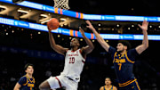 Mar 12, 2025; Charlotte, NC, USA; Stanford Cardinal forward Chisom Okpara (10) shoots as California Golden Bears forward Spencer Mahoney (7) defends in the first half at Spectrum Center. Mandatory Credit: Bob Donnan-Imagn Images