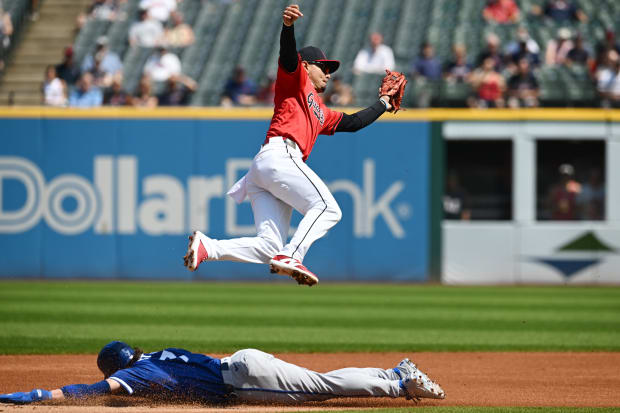 Andres Gimenez leaps for a throw to second base 