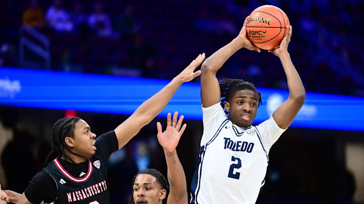 Mar 13, 2026; Cleveland, OH, USA; Toledo Rockets guard Leroy Blyden Jr. (2) looks to pass as Massachusetts Minutemen guard Danny Carbuccia (0) defends during the first half at Rocket Arena Mandatory Credit: Ken Blaze-Imagn Images