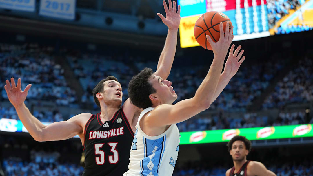 Feb 23, 2026; Chapel Hill, North Carolina, USA; North Carolina Tar Heels guard Luka Bogavac (44) shoots as Louisville Cardinals forward Vangelis Zougris (53) defends in the second half at Dean E. Smith Center. Mandatory Credit: Bob Donnan-Imagn Images Feb 23, 2026; Chapel Hill, North Carolina, USA; North Carolina Tar Heels guard Luka Bogavac (44) shoots as Louisville Cardinals forward Vangelis Zougris (53) defends in the second half at Dean E. Smith Center. Mandatory Credit: Bob Donnan-Imagn Images