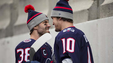 Mar 1, 2025; Columbus, Ohio, USA;  Columbus Blue Jackets center Boone Jenner (38) reacts with left wing Dmitri Voronkov (10) during warmups before the game against the Detroit Red Wings at Ohio Stadium. Mandatory Credit: Aaron Doster-Imagn Images