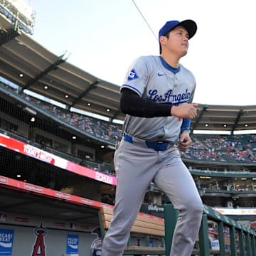 Sep 3, 2024; Anaheim, California, USA;  Los Angeles Dodgers designated hitter Shohei Ohtani (17) runs out of the dugout to warm up for the game against the Los Angeles Angels at Angel Stadium. Mandatory Credit: Jayne Kamin-Oncea-Imagn Images