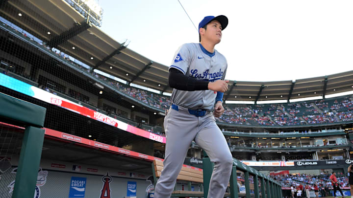 Sep 3, 2024; Anaheim, California, USA;  Los Angeles Dodgers designated hitter Shohei Ohtani (17) runs out of the dugout to warm up for the game against the Los Angeles Angels at Angel Stadium. Mandatory Credit: Jayne Kamin-Oncea-Imagn Images