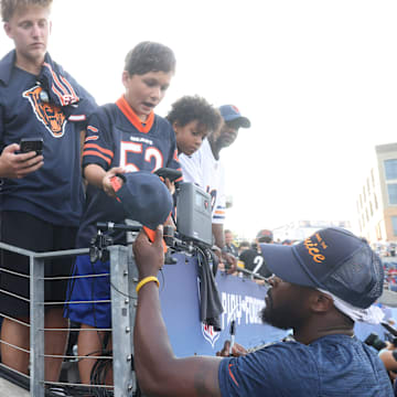 Caleb Williams signs autographs during preseason. Bears fans are in love with him now but times can be tough for rookie QBs.