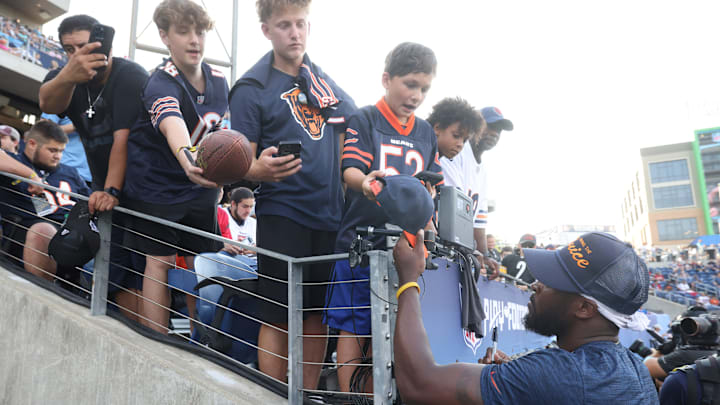 Caleb Williams signs autographs during preseason. Bears fans are in love with him now but times can be tough for rookie QBs.