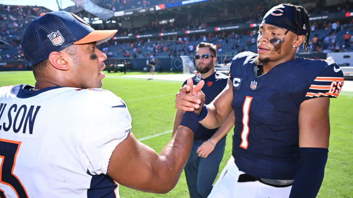 Quarterbacks Justin Fields and Russell Wilson meet midfield after their 2023 game at Soldier Field. 