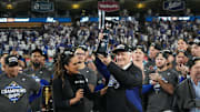 Oct 17, 2025; Los Angeles, California, USA; Los Angeles Dodgers owner Mark Walter is presented the NLCS trophy by TBS reporter Lauren Shehadi after game four of the NLCS round for the 2025 MLB playoffs against the Milwaukee Brewers at Dodger Stadium. Mandatory Credit: Kirby Lee-Imagn Images