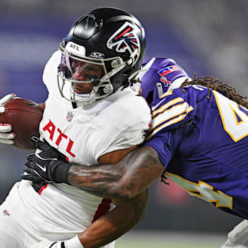 Sep 14, 2025; Minneapolis, Minnesota, USA; Atlanta Falcons running back Bijan Robinson (7) runs the ball during the first half as Minnesota Vikings safety Joshua Metellus (44) defends at U.S. Bank Stadium. Mandatory Credit: Jeffrey Becker-Imagn Images