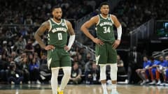 Damian Lillard and Giannis Antetokounmpo stand on the court