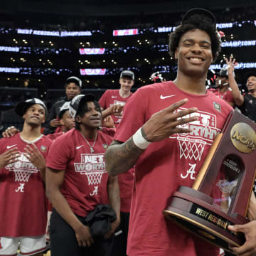 Mar 30, 2024; Los Angeles, CA, USA; Alabama Crimson Tide forward Nick Pringle (23) celebrates with the trophy after defeating the Clemson Tigers in the finals of the West Regional of the 2024 NCAA Tournament at Crypto.com Arena. Mandatory Credit: Jayne Kamin-Oncea-USA TODAY Sports