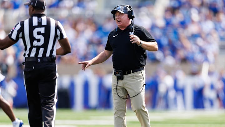 Sep 21, 2024; Lexington, Kentucky, USA; Kentucky Wildcats head coach Mark Stoops speaks to a referee during the first quarter against the Ohio Bobcats at Kroger Field. Mandatory Credit: Jordan Prather-Imagn Images